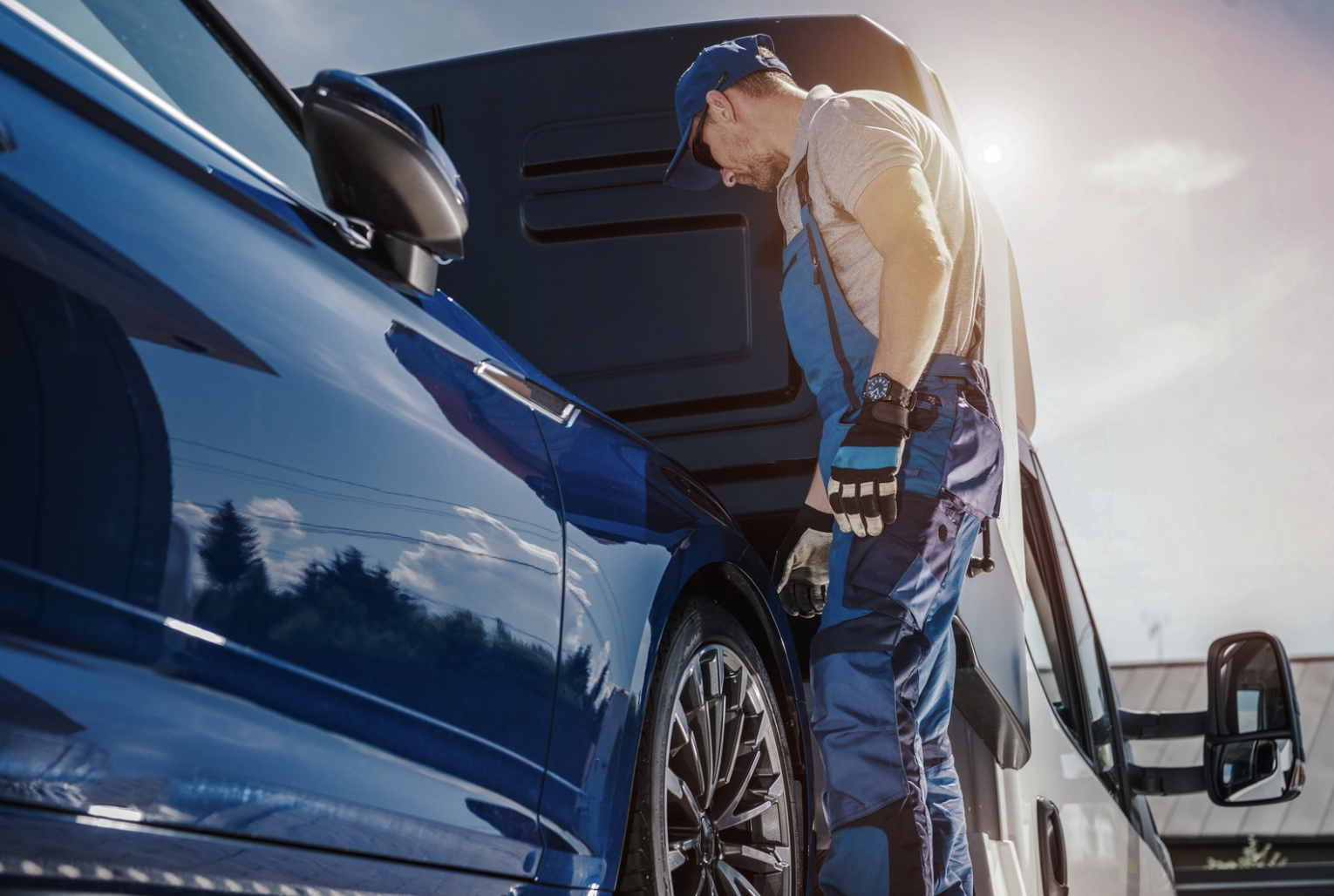 man loading car transport